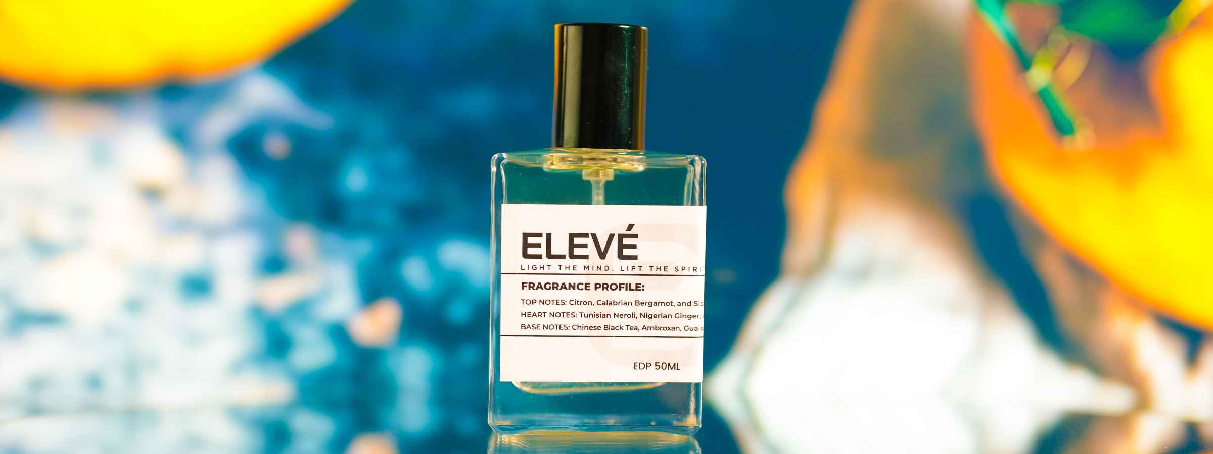 ELEVÉ perfume bottle with black cap on abstract blue-orange background, 50ml.